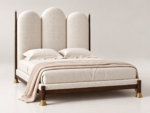 Arched upholstered bed Qatar – ivory triple-panel headboard with dark wood frame and brass legs]