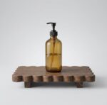 Original solid wood home decor rack with scalloped edge holding a soap dispenser and potted ivy