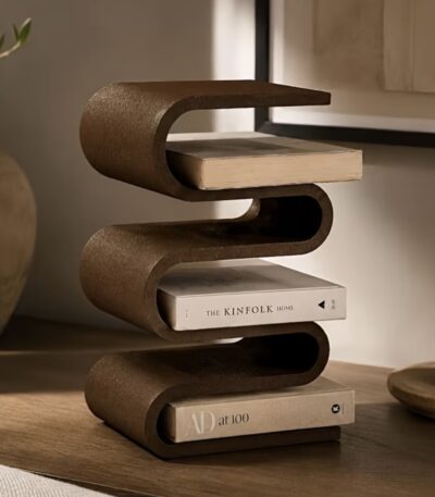 Yellow leather book band holding stack of books on nightstand