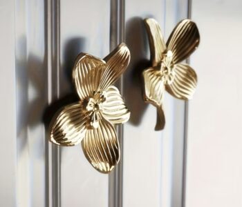 Gold orchid flower cabinet knobs on silver glass door