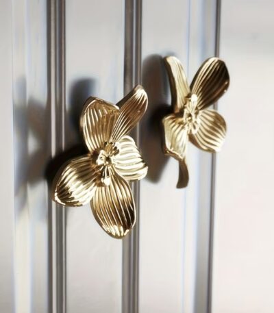 Gold orchid flower cabinet knobs on silver glass door