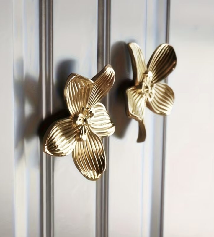 Gold orchid flower cabinet knobs on silver glass door