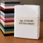 White fitted sheet smoothly fitted on a mattress in a bright bedroom