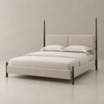 Arden upholstered four-poster bed with oatmeal fabric split headboard, slim wooden posts and dark bronze metal details