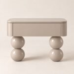 Pearl taupe nightstand with one drawer and glossy stacked sphere legs